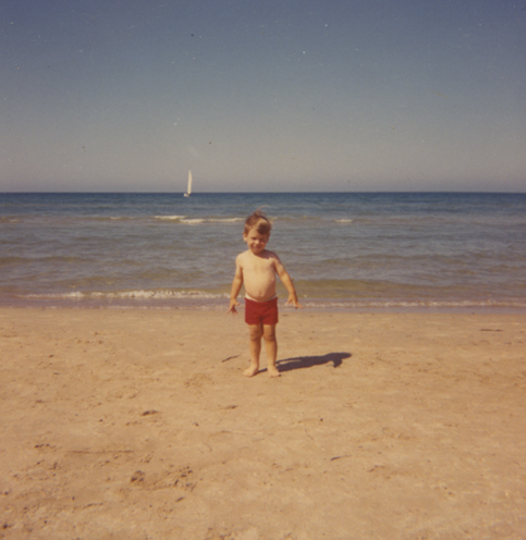 Little boy on the beach faded 1960's snapshot