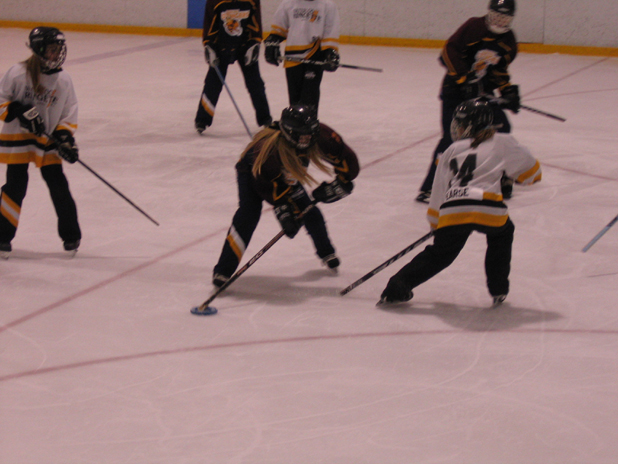 This ringette duel suffers from low light and a poor exposure.