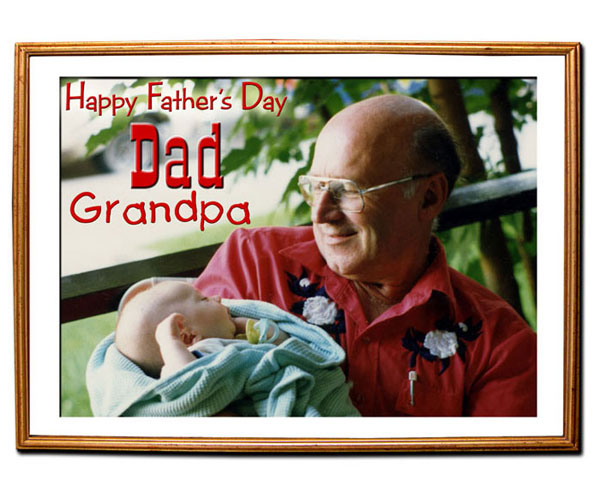 Father holds grandson in a gold matte picture frame.