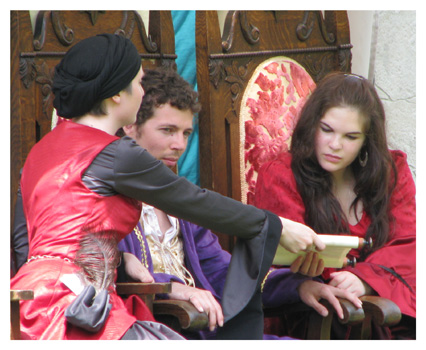 Maid Marion pays attention while the Inquisitor negotiates with Prince John